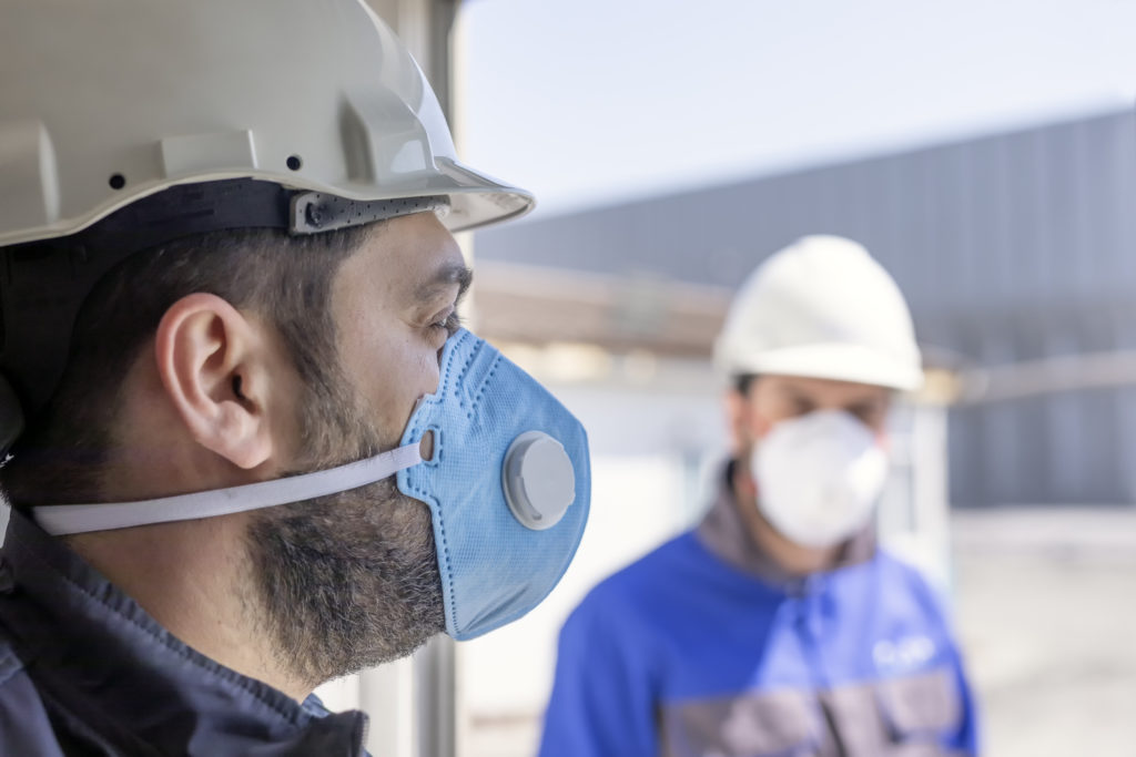 The workers are using PPE and navigating Pandemic Construction Trends.