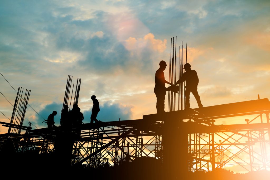 Silhouette of engineer and construction team working at construction site