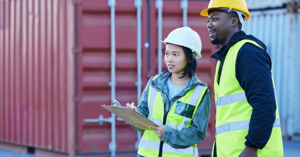 Man and woman collaborating at construction job site to offer excellent customer service to the building owner.
